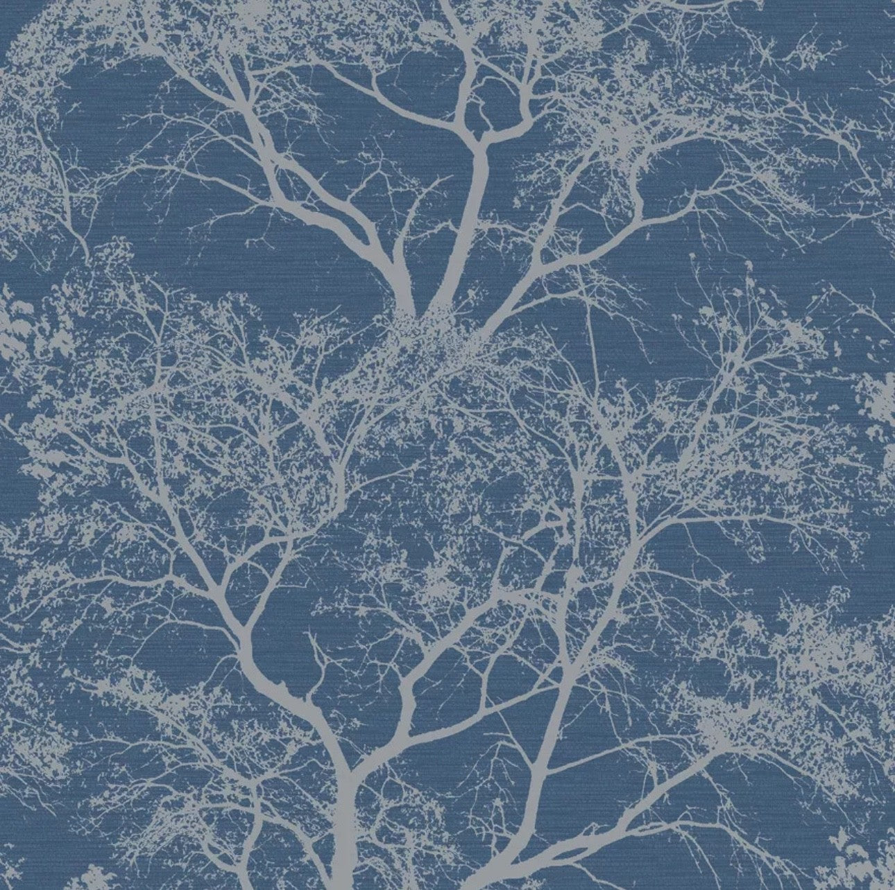 Holden Decor Whispering Trees Wallpaper in Blue Sparkle featuring a blue background with white tree silhouettes.
